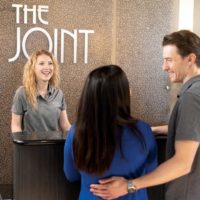 The Joint Chiropractic franchise customers talk to receptionist
