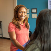 The Joint employee greeting customer